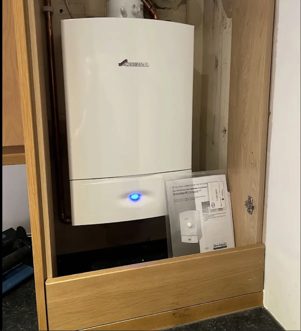 A new Worcester Bosch boiler neatly installed in a kitchen cupboard by Drake Boilers
